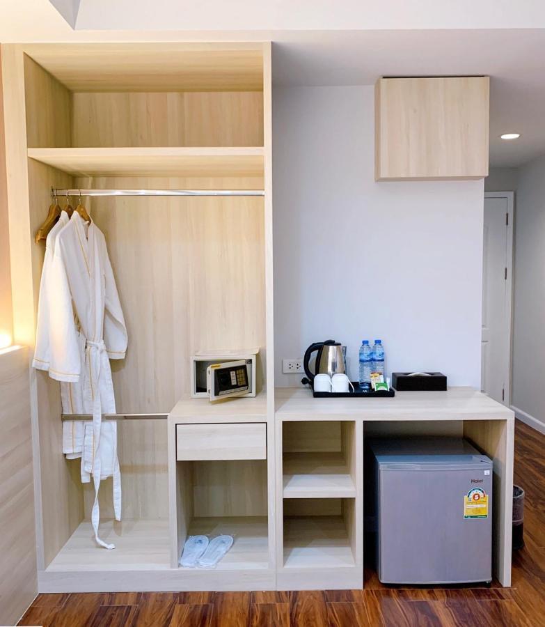 Miloft Sathorn Hotel - Sha Plus Certified Bangkok Exterior photo A hotel room with a bathrobe